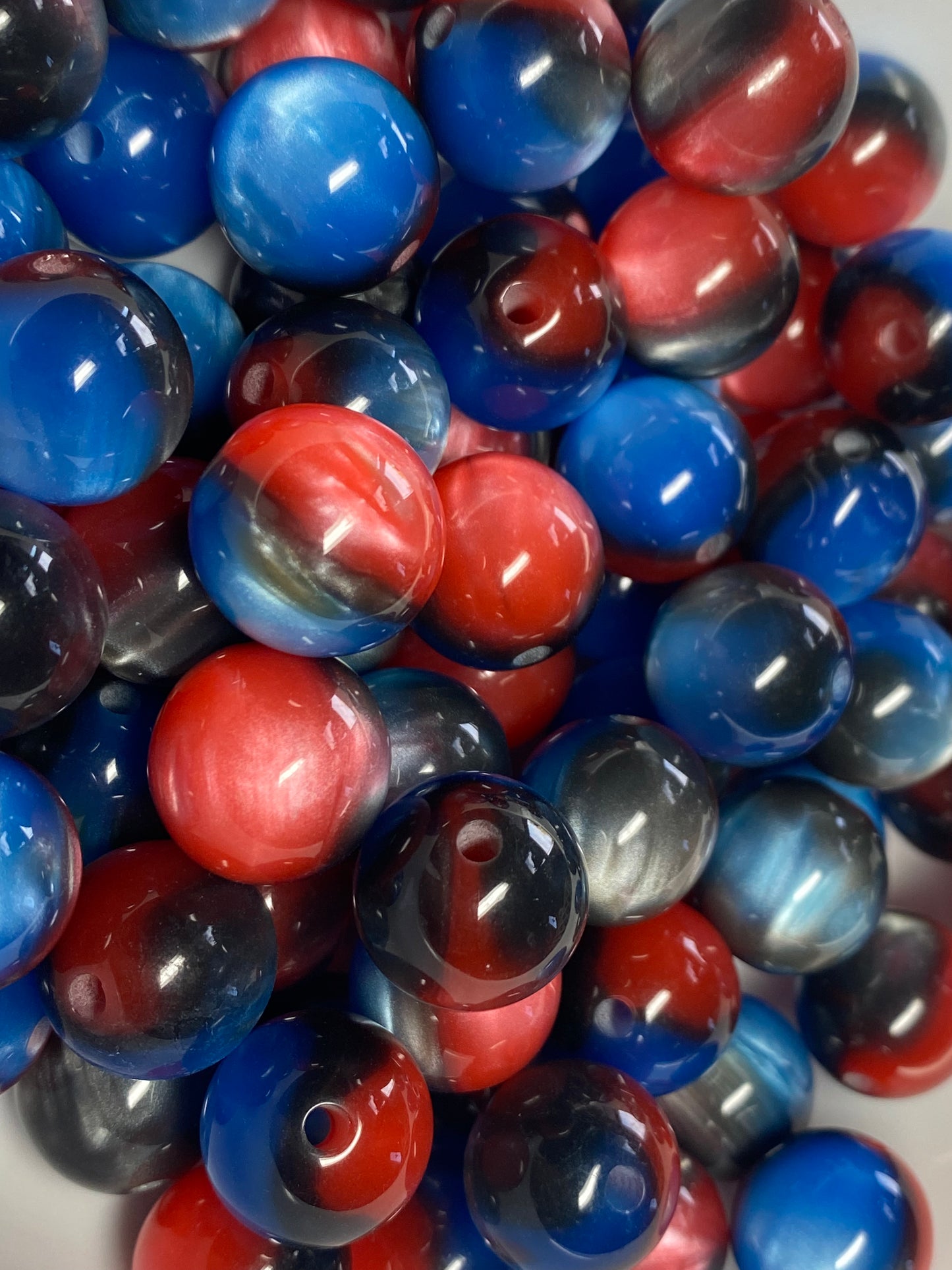 16mm cat’s eye black, red, and blue beads