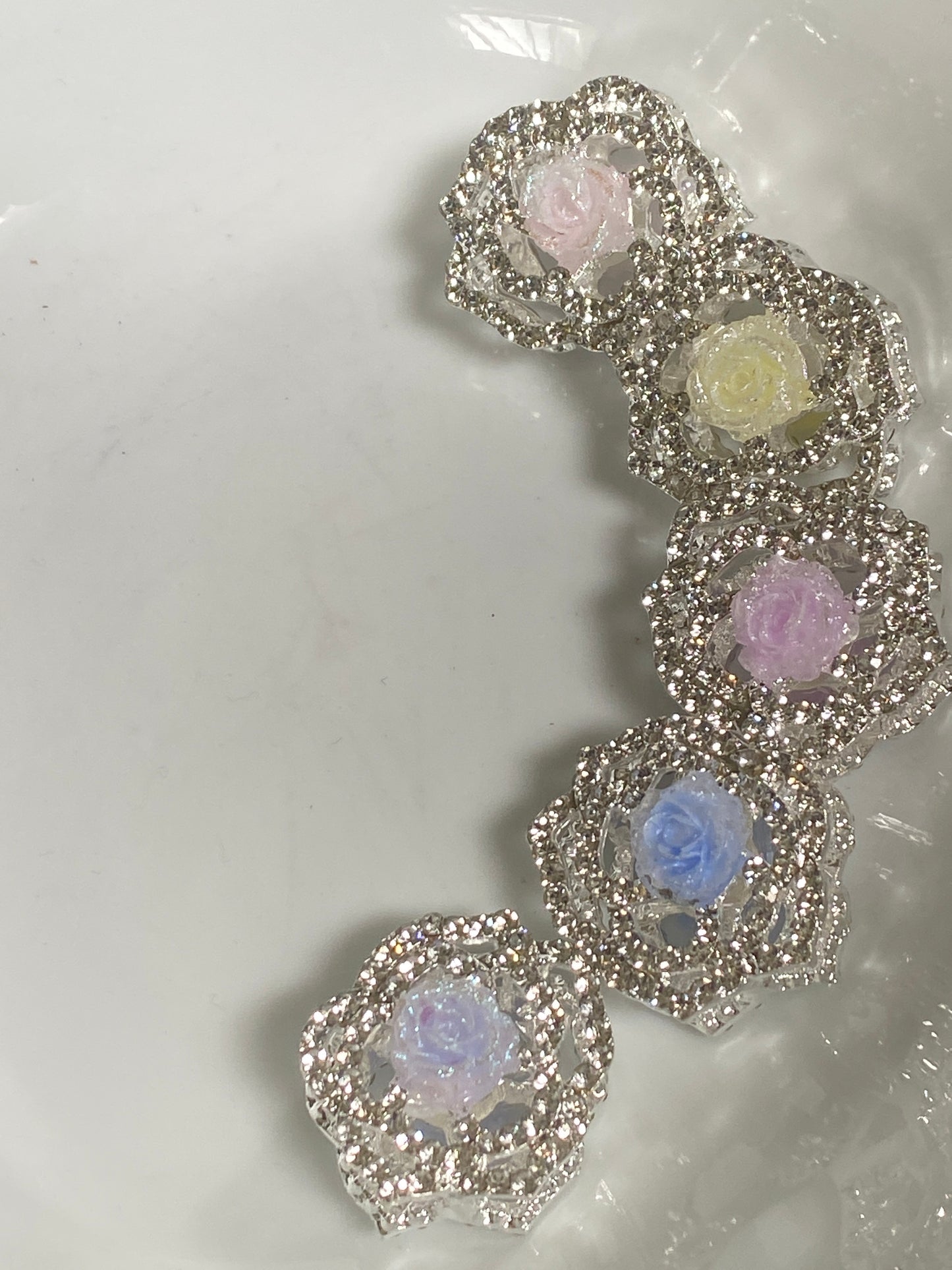 20mm metal four hole rhinestone encrusted bead with a soft rose bud