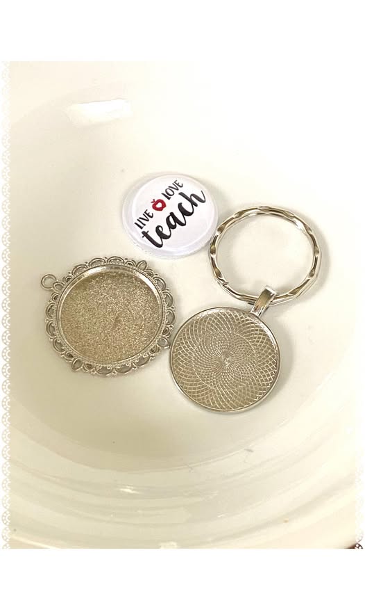 Metal keychain/pendant housing for glass button charms.