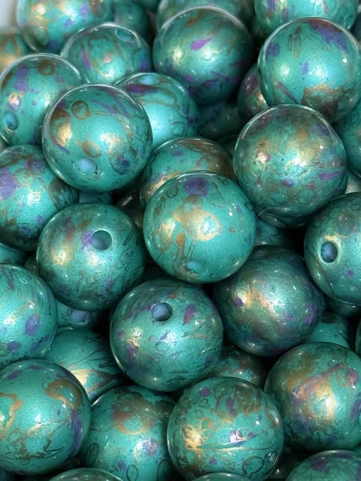 16mm spilled ink teal, purple, and gold.