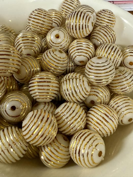 20mm bright gold with indentation on a white base bead.