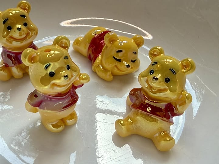 30mm uv coated cute little Pooh bear beads.