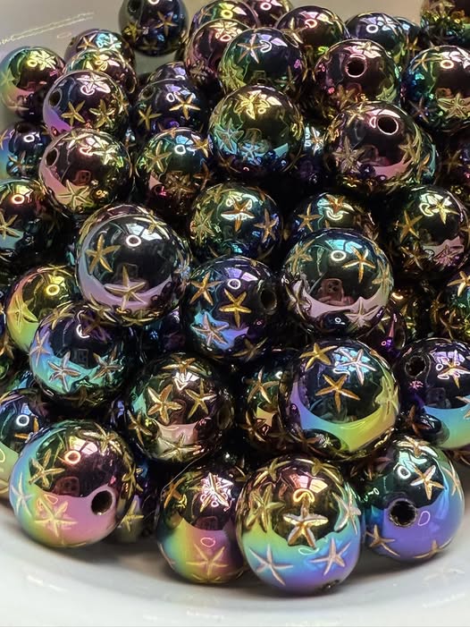 16mm uv coated black etched star bead with gold accents.