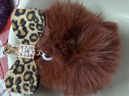 3" Fuffy pompom with chain and lobster claw hardware.