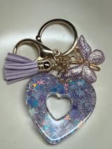 Resin filled heart shaped pendant with all gold hardware, an adorable little tassel and finally a stunning butterfly