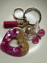 Resin filled heart shaped pendant with all gold hardware, an adorable little tassel and finally a stunning butterfly