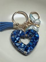 Resin filled heart shaped pendant with all gold hardware, an adorable little tassel and finally a stunning butterfly