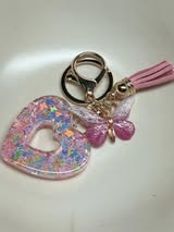 Resin filled heart shaped pendant with all gold hardware, an adorable little tassel and finally a stunning butterfly