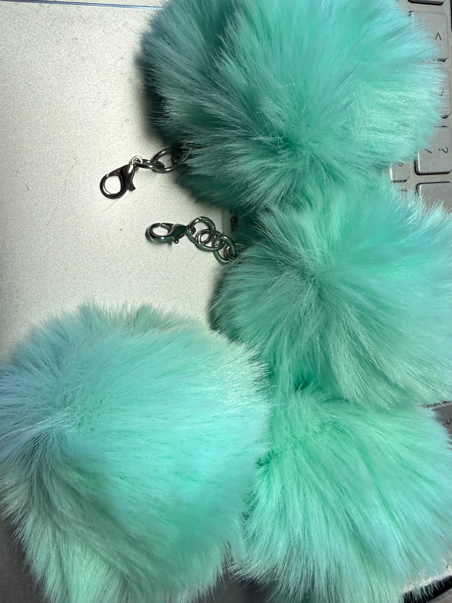 3" Fuffy pompom with chain and lobster claw hardware.